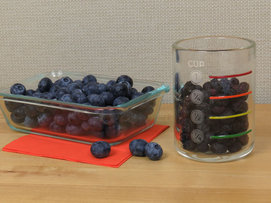 Whole blueberries in measuring cup